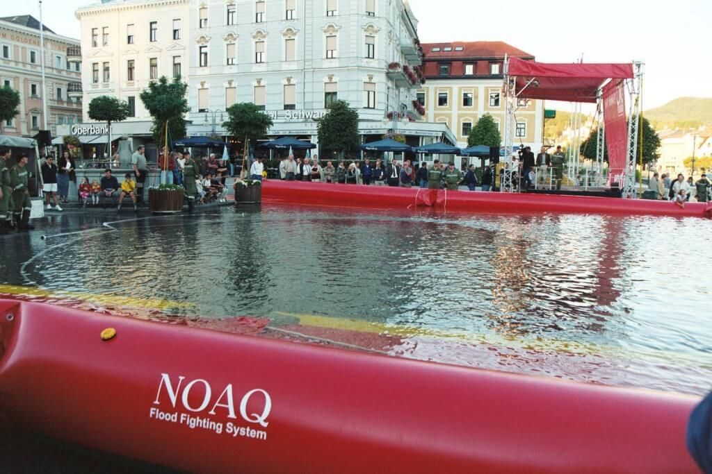 Inflatable flood barrier used as a flood tube to protect homes from flooding