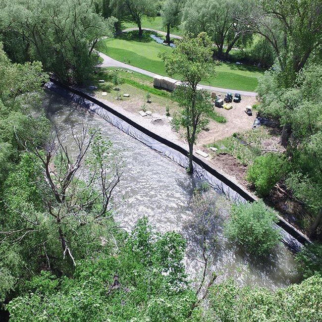 Overhead view of Muscle Wall being used to provide flood protection from an overflowing river.