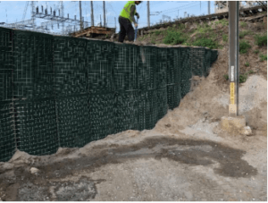 In this example, the bottom of the HESCO was cut to conform to the angle of the levee the floodwall was being tied into. We prefer this method because there is no digging into the levee, no disturbed soils, and therefore, less potential for scouring of loose soils during a flood event.