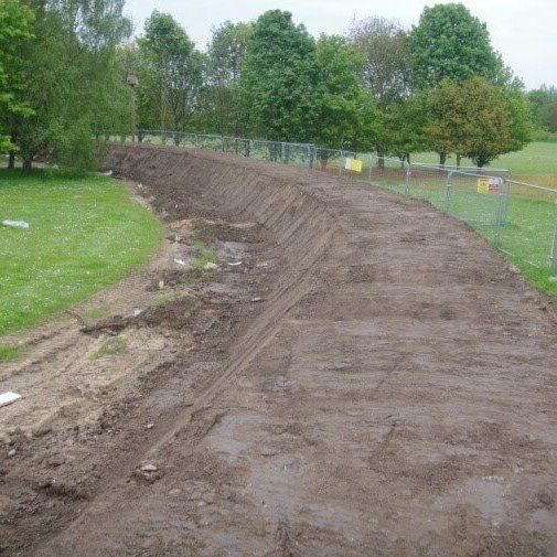 DIY Berm for flood protection before landscaping to protect a home from flooding using a geogrid system