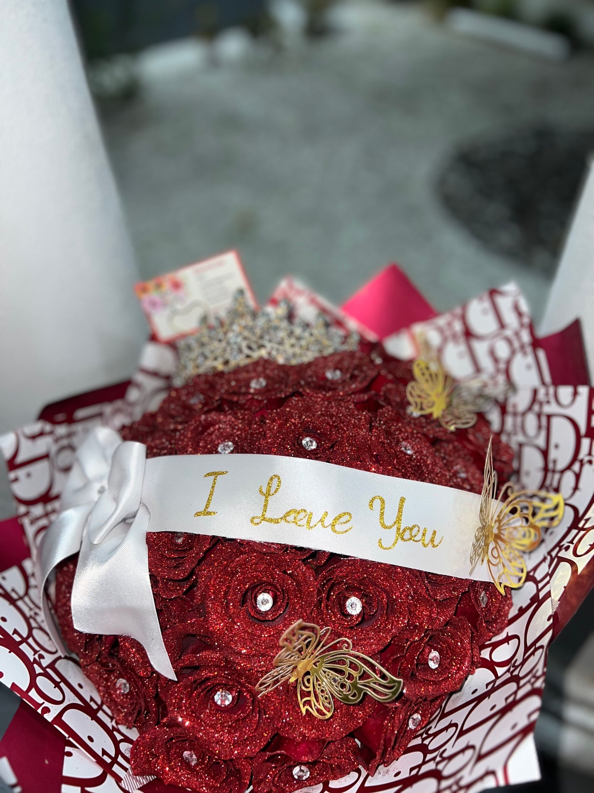 A bouquet of red roses with a ribbon that says `` i love you ''