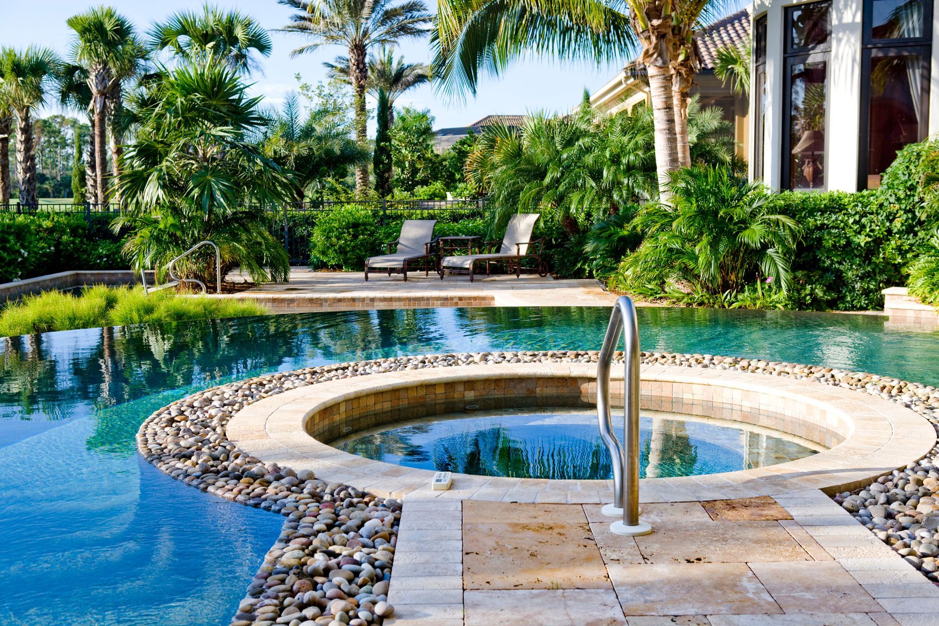 A large swimming pool with a hot tub in the middle