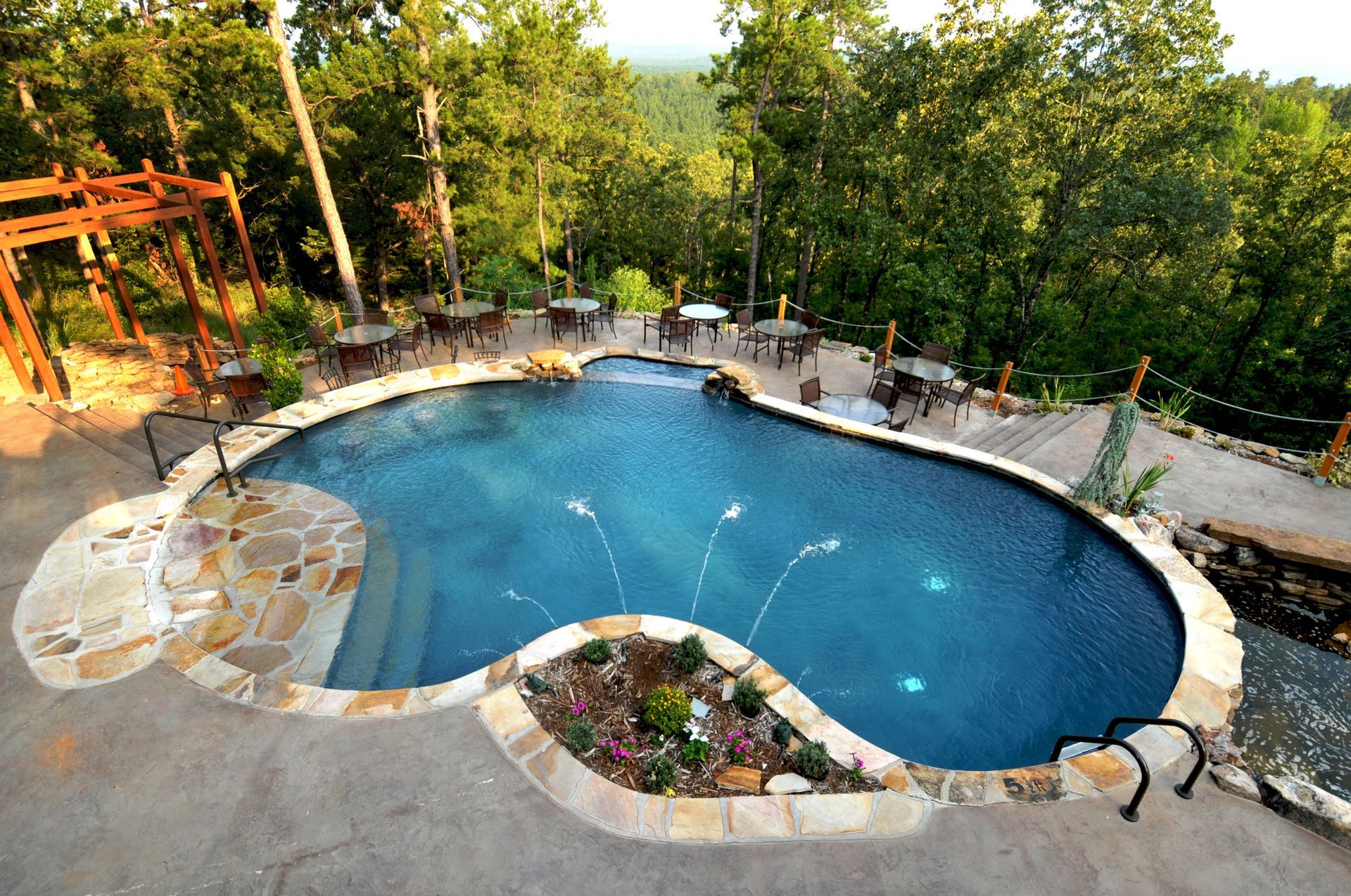 A large swimming pool in the middle of a forest