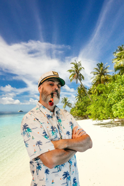 Man in a tropical shirt and captain’s hat on a sunny beach with palm trees and blue sky