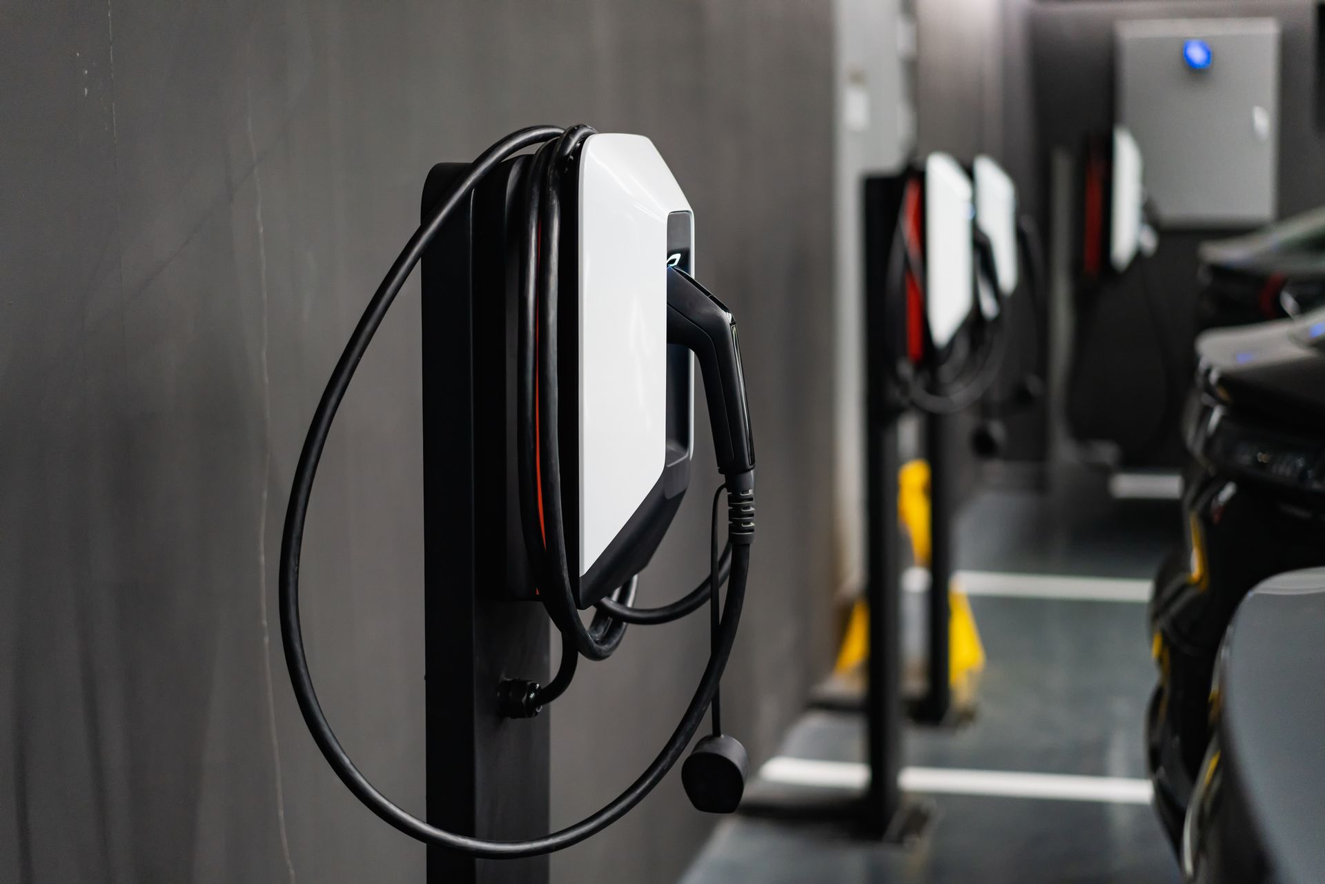 An electric car is being charged at an ev charging station. An electric car is being charged at an ev charging station.