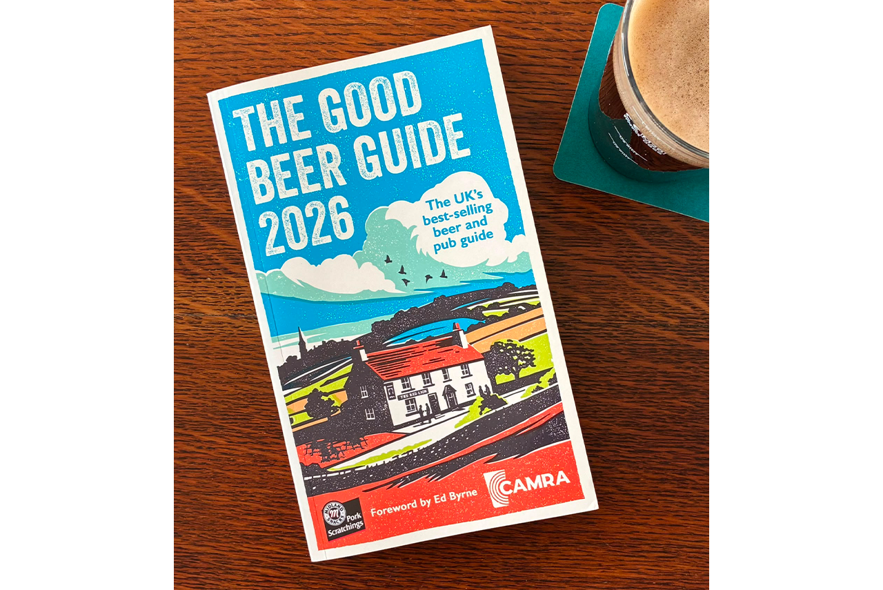 The Good Beer Guide 2026 on a wooden table beside a glass of beer