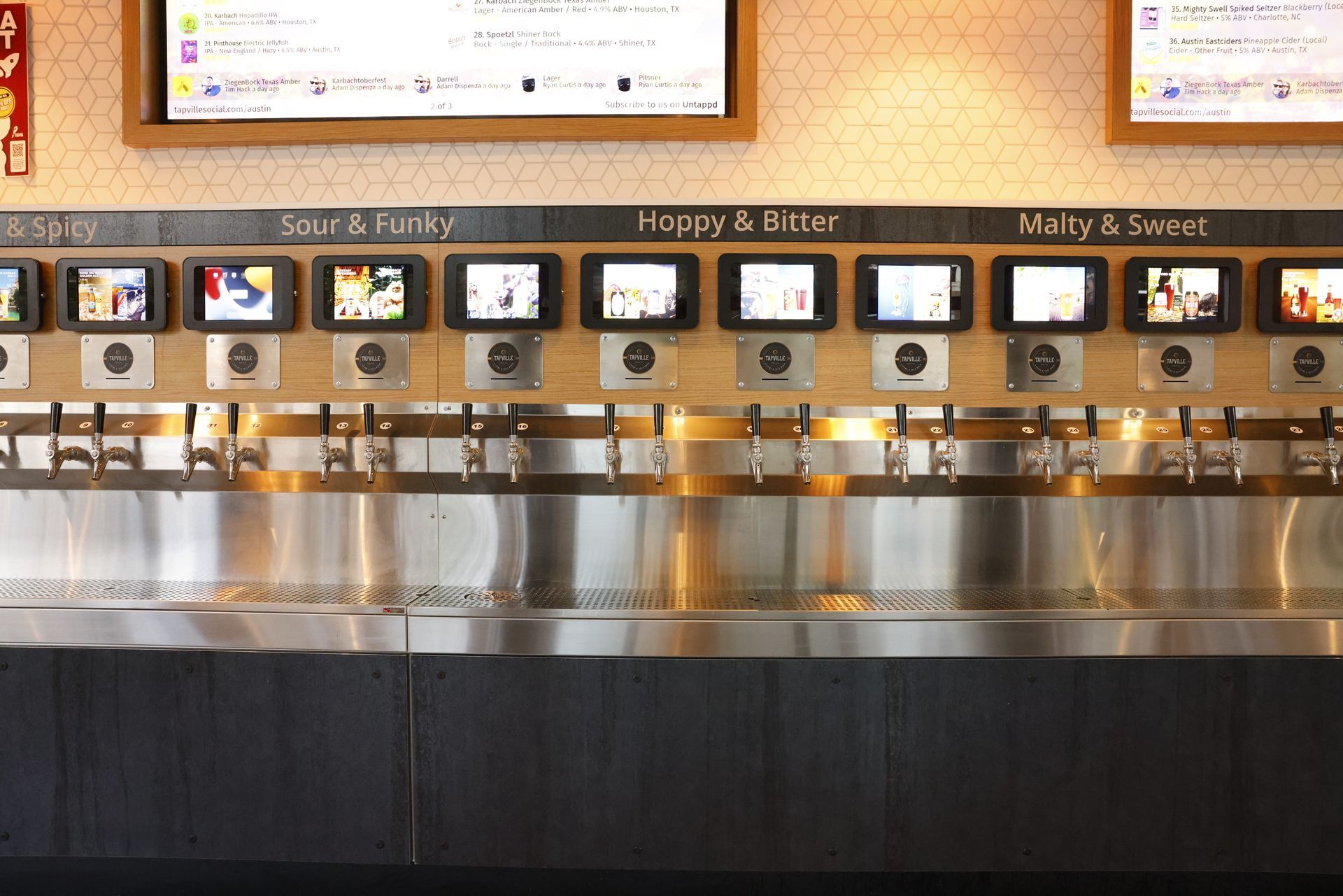 Self-serve beer wall, with multiple taps and screens to show products and tasting notes