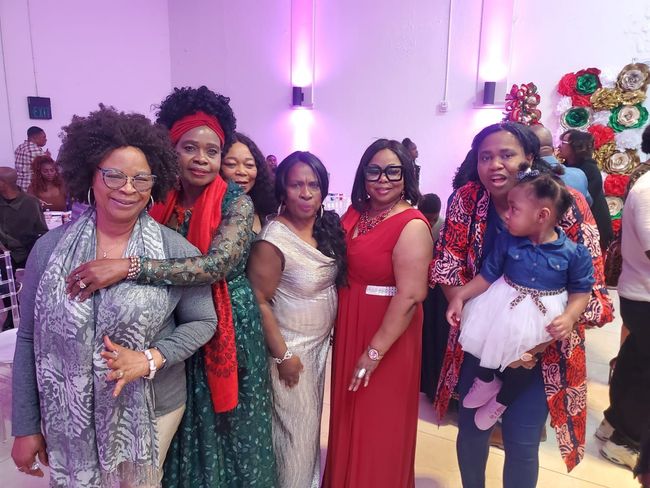 A group of women are posing for a picture at a party.
