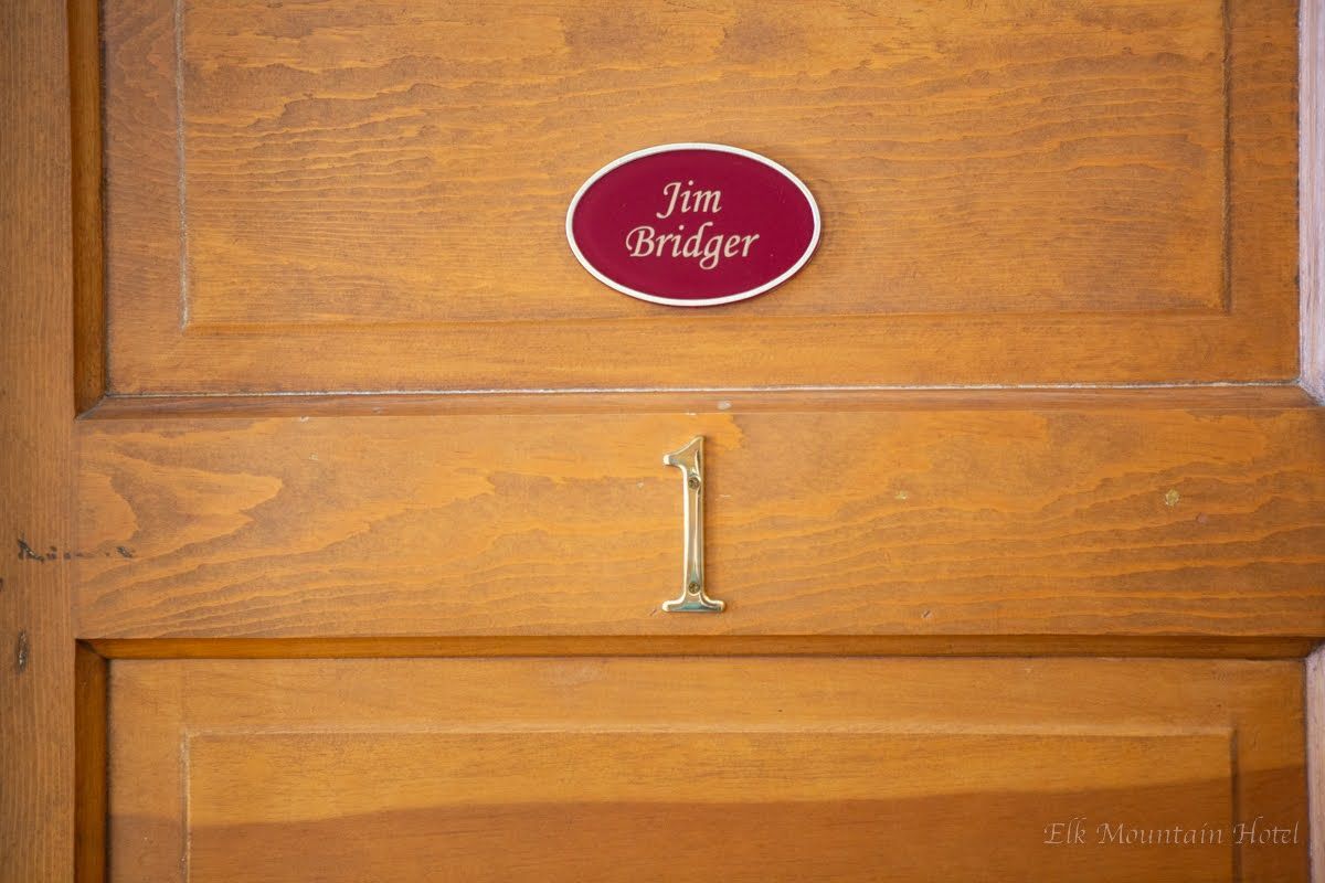 A wooden door with a sign that says jim bridger on it.