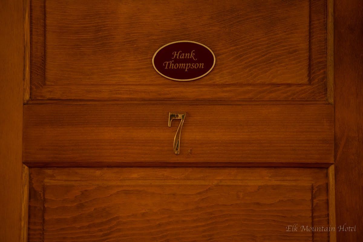 A wooden door with a sign on it that says paul thompson