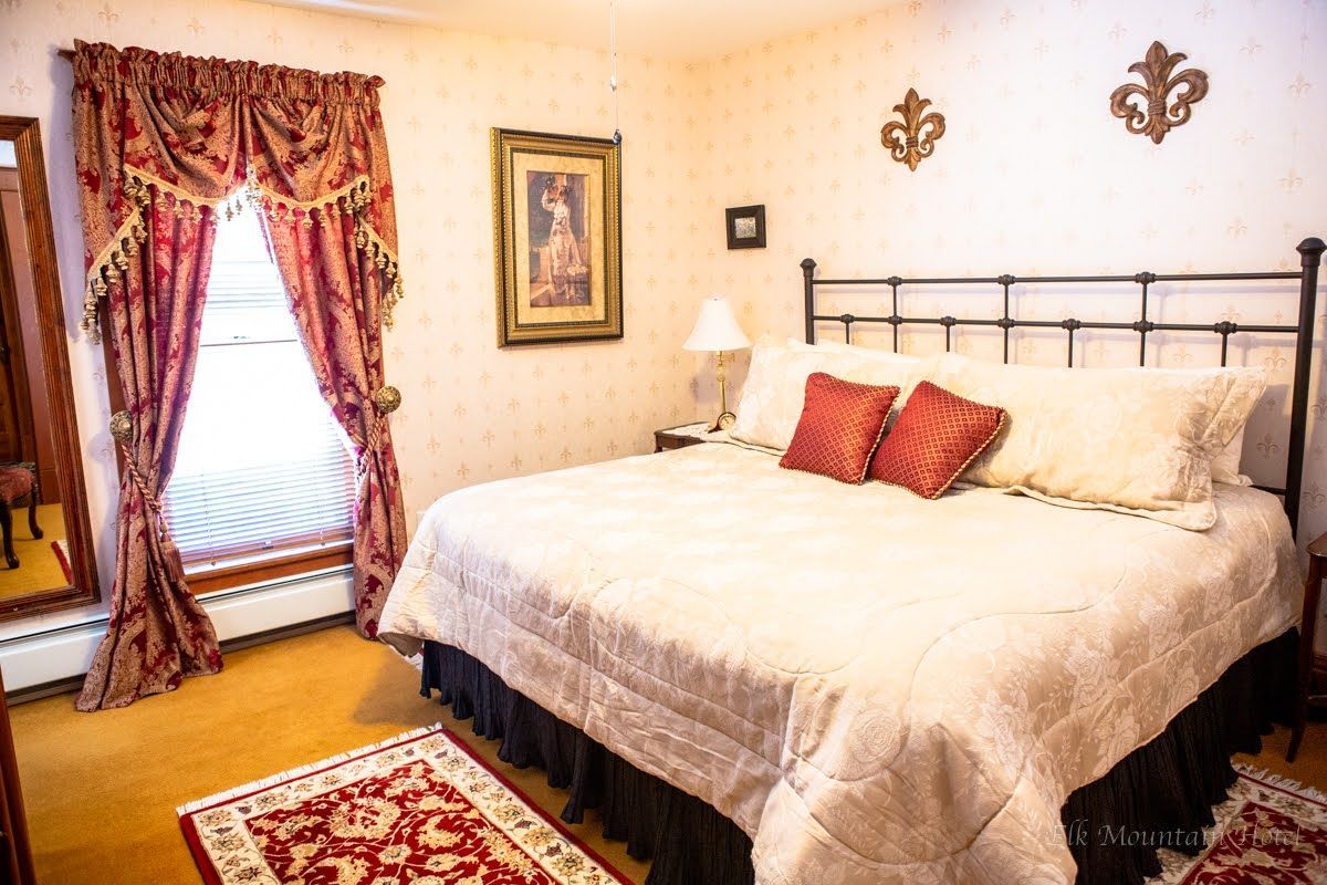 A bedroom with a large bed and a window