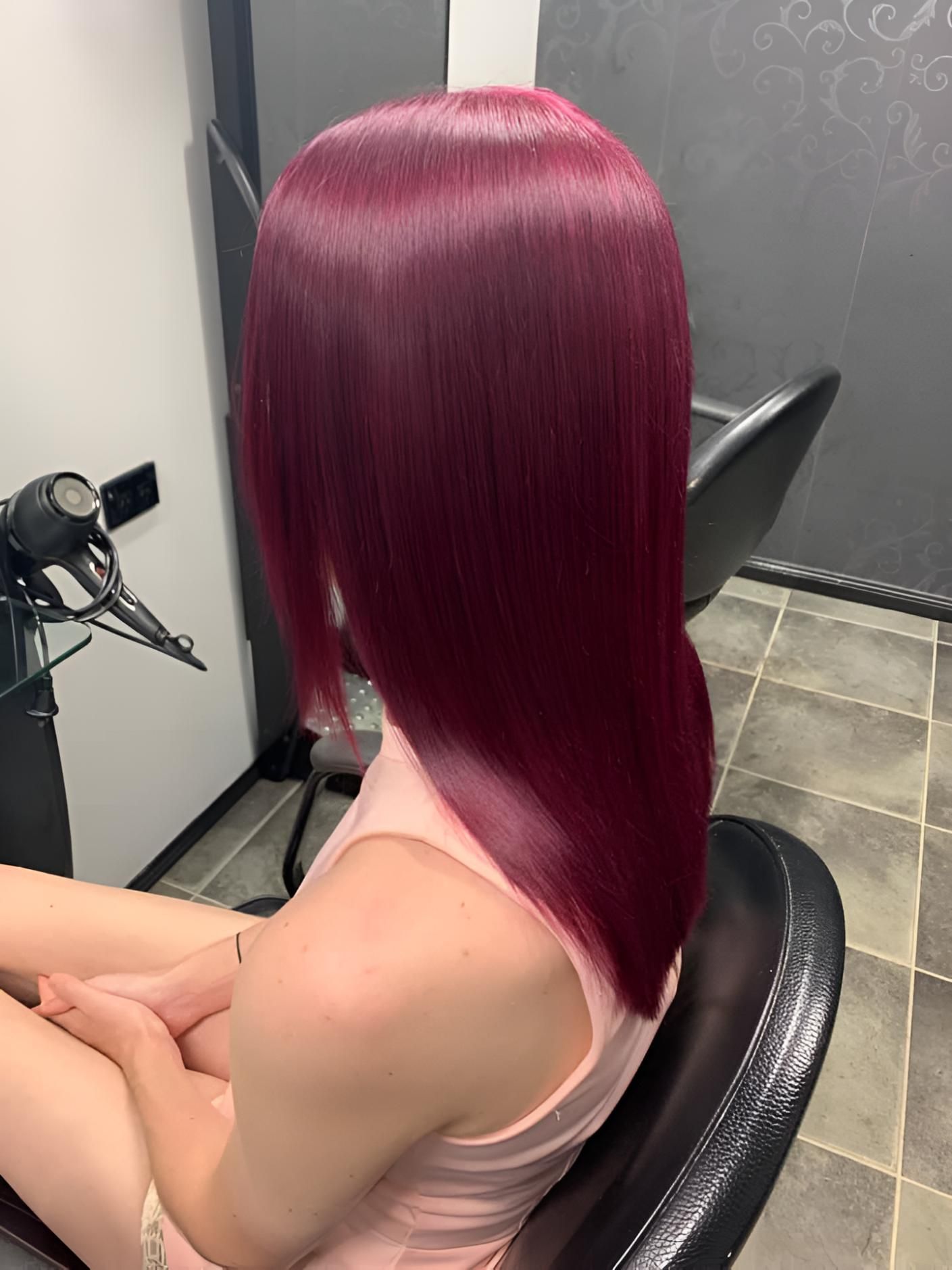 A Woman With Red Hair Is Sitting In A Chair In A Salon — Klic's Hair Design In Earlville, QLD