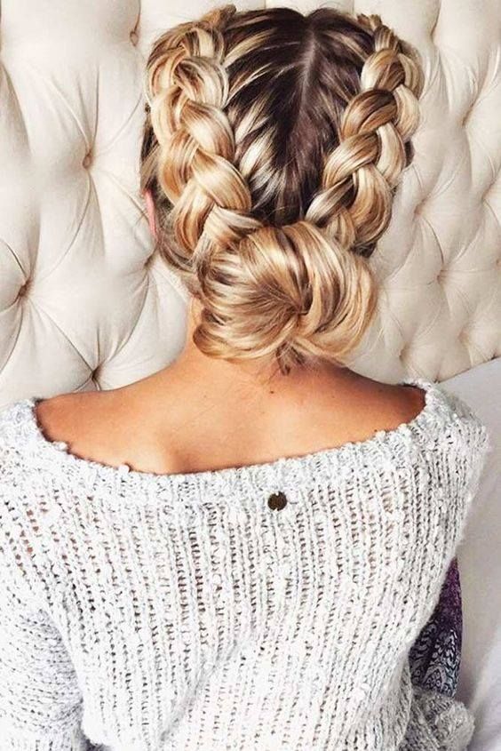 A Woman Is Wearing A Sweater And Has Her Hair In A Braided Bun — Klic's Hair Design In Earlville, QLD