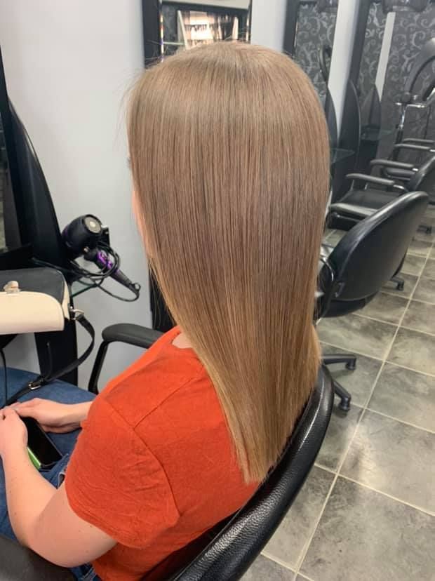 A Woman Is Sitting In A Chair In A Hair Salon — Klic's Hair Design In Earlville, QLD