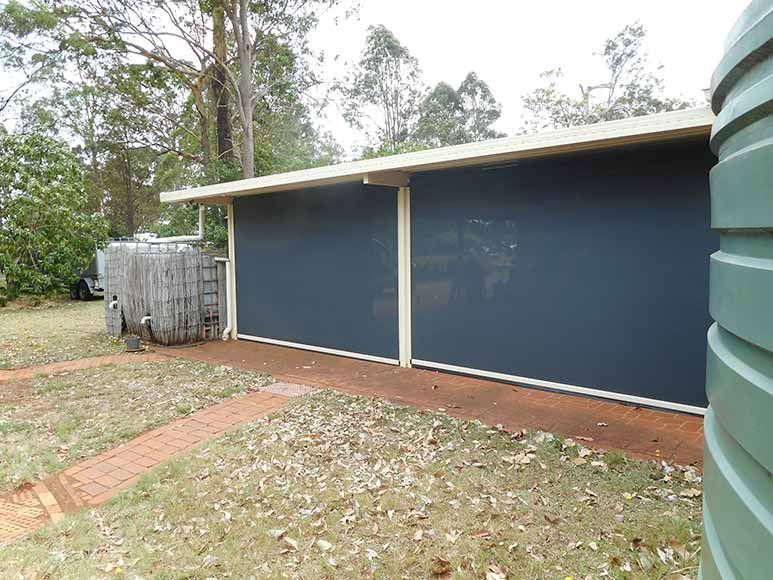 Dark Blue Roll-down Blinds on a Building With a Brick Walkway — Toowoomba Shade & Canvas in Harristown, QLD