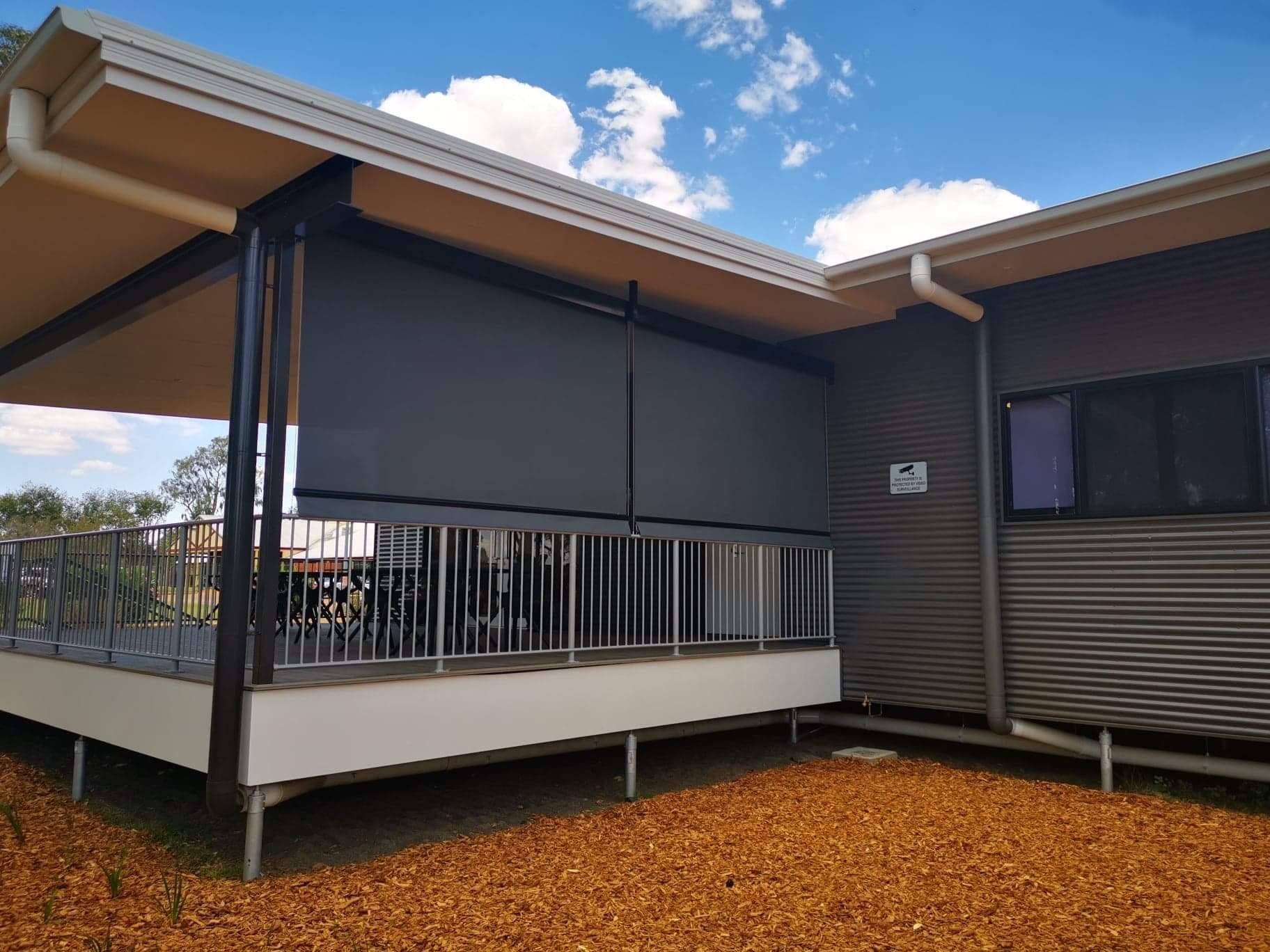 A Building With a Veranda, Dark Gray Sunshade, Brown Gravel — Toowoomba Shade & Canvas in Harristown, QLD