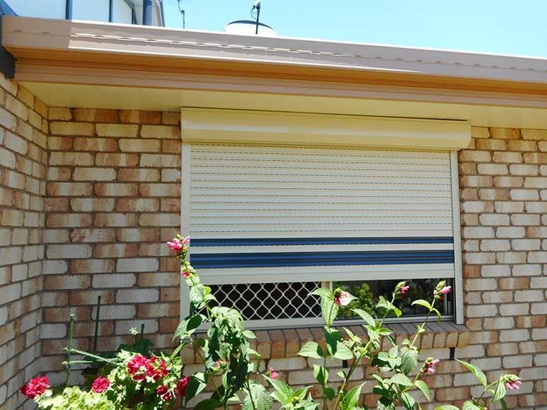 Window With Closed Cream-colored Roller Shutter, Blue Stripes — Toowoomba Shade & Canvas in Harristown, QLD