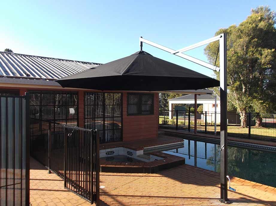 Black Cantilever Umbrella Shading a Pool Deck — Toowoomba Shade & Canvas in Harristown, QLD
