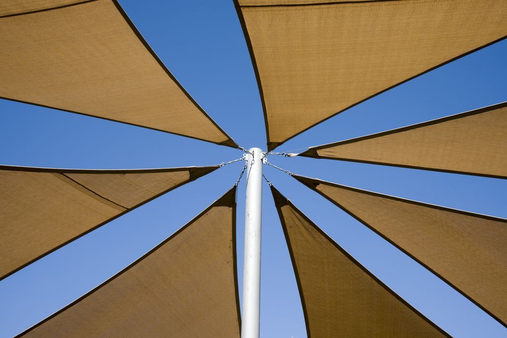 Brown Shade Sails Radiating From a White Central Pole — Toowoomba Shade & Canvas in Harristown, QLD
