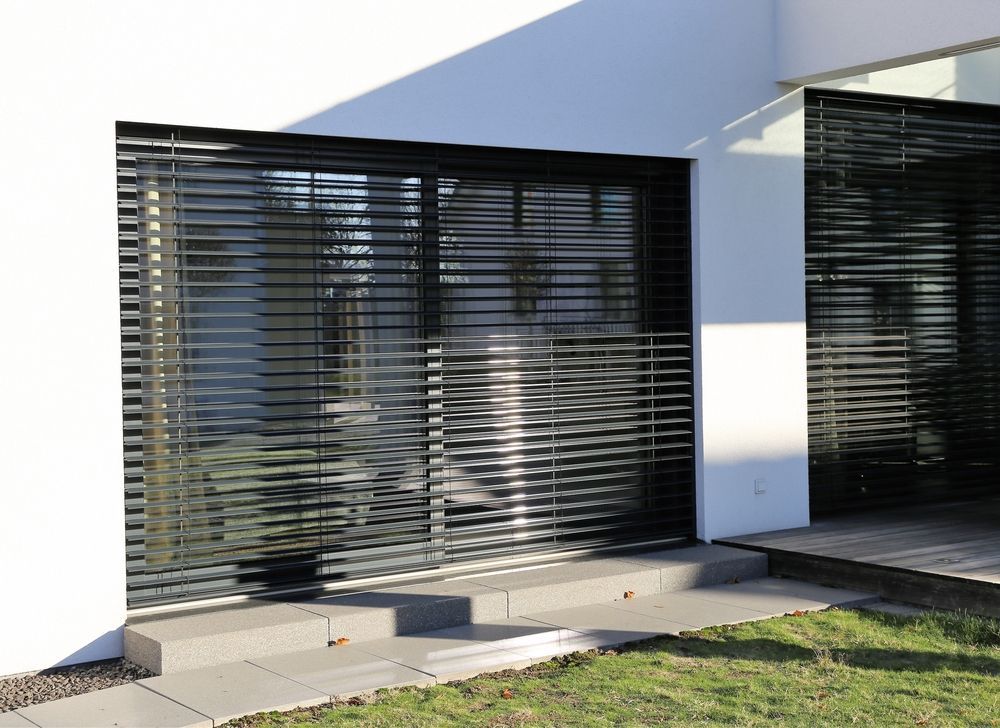Modern White Building With Black Horizontal Blinds Over Windows — Toowoomba Shade & Canvas in Dalby, QLD
