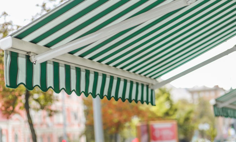 Green and White Striped Awning Over a Storefront — Toowoomba Shade & Canvas in Dalby, QLD