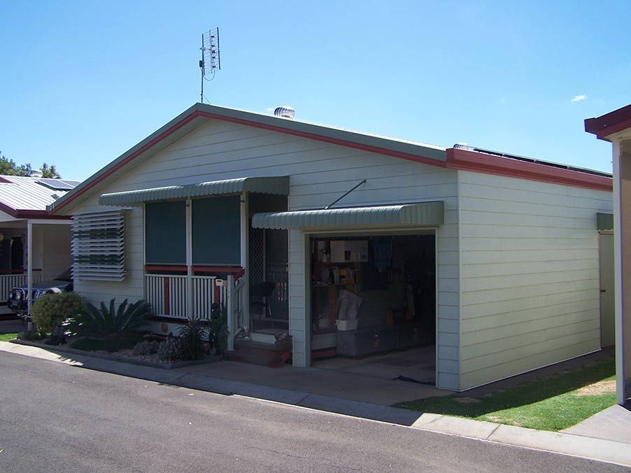 Light Yellow One-story House With Garage and Awning Under a Blue Sky — Toowoomba Shade & Canvas in Harristown, QLD