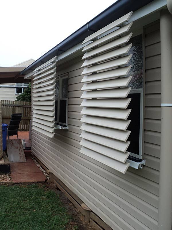 Exterior View of a House With Open, Beige-colored Louvered Shutters — Toowoomba Shade & Canvas in Harristown, QLD