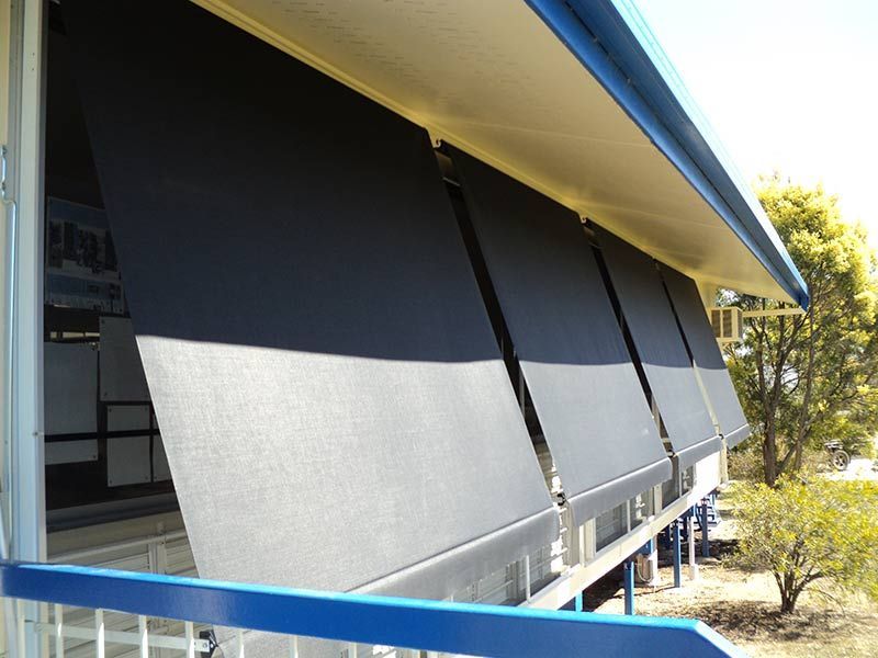Black Sunshades Partially Lowered on a Building's Balcony — Toowoomba Shade & Canvas in Harristown, QLD