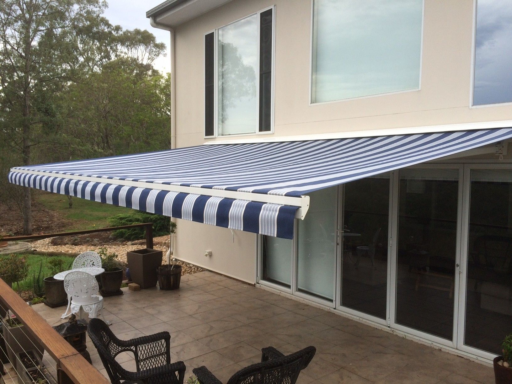 Blue and White Striped Awning Over a Patio — Toowoomba Shade & Canvas in Harristown, QLD