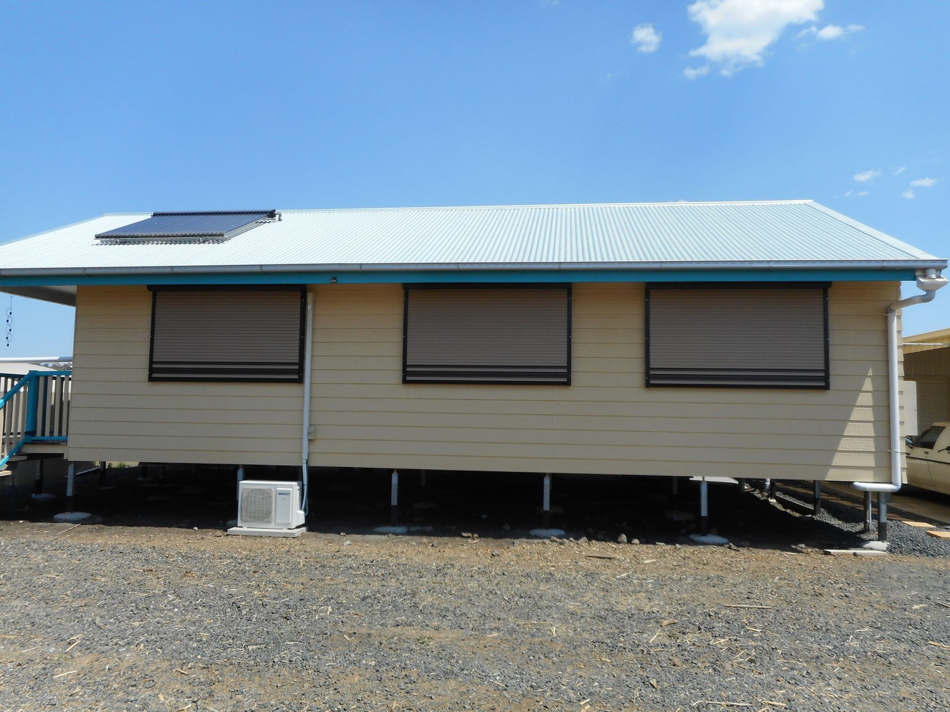 Tan House on Stilts With Brown Window Shades — Toowoomba Shade & Canvas in Harristown, QLD