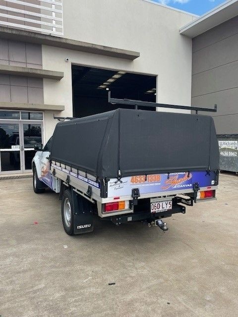White Isuzu Utility Vehicle With a Black Canopy in Front of a Building — Toowoomba Shade & Canvas in Harristown, QLD
