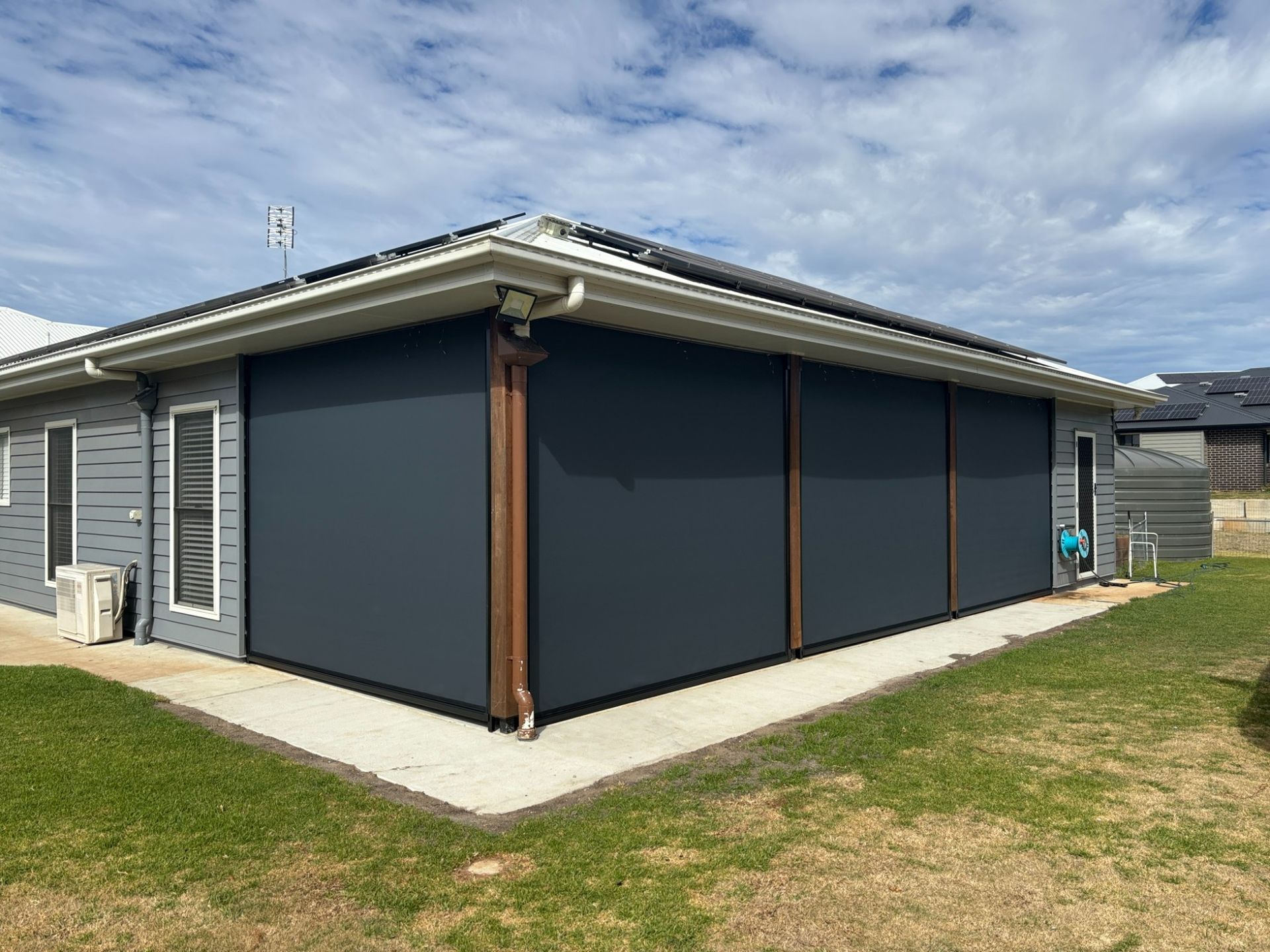 Exterior View of a Gray House With Large, Dark Gray Outdoor Blinds — Toowoomba Shade & Canvas in Harristown, QLD