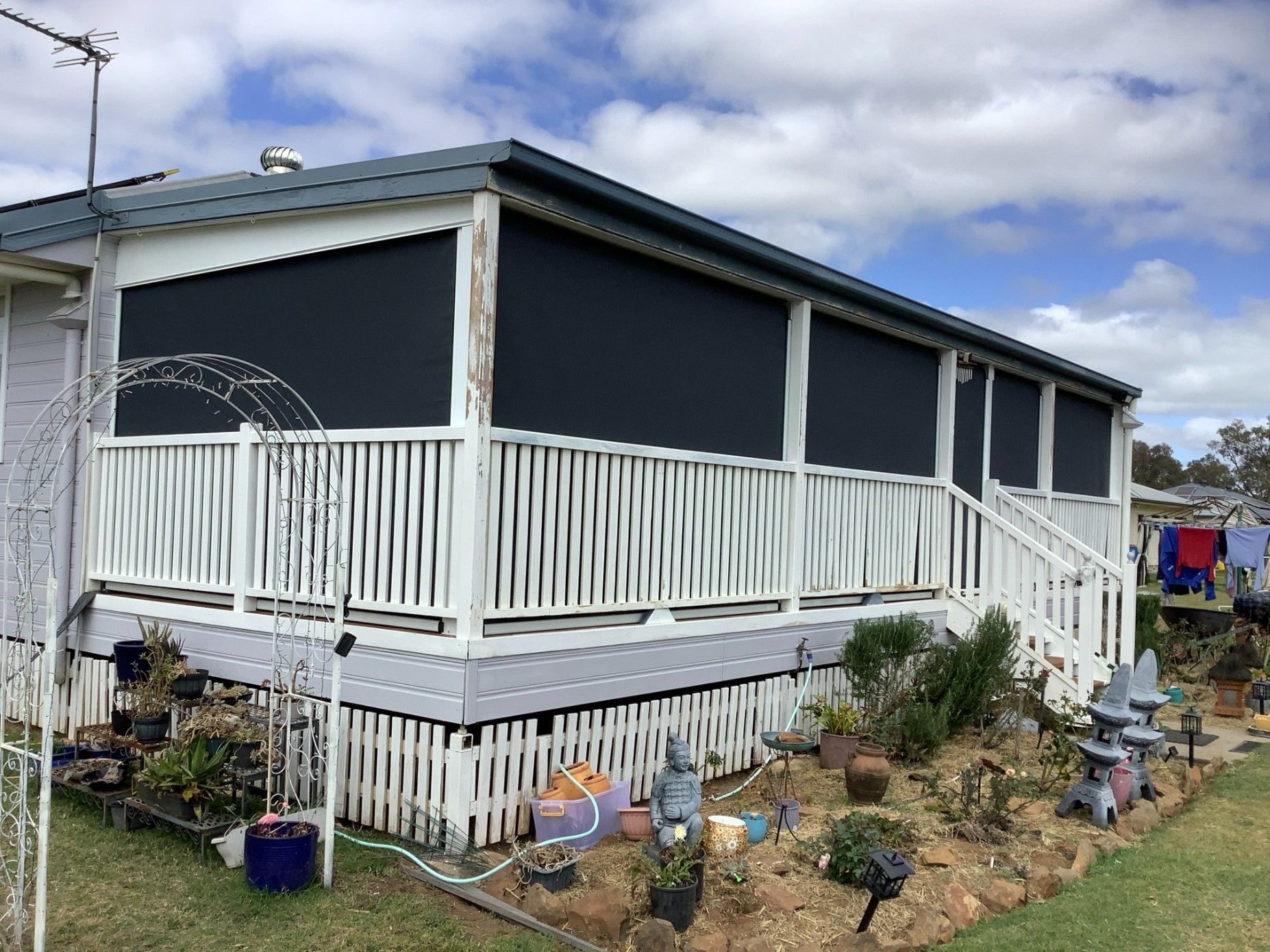 A House With a Deck and Black Roll-down Shades — Toowoomba Shade & Canvas in Highfields, QLD