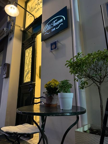 A bistro table and chairs sit outside the entrance of