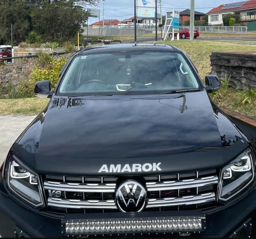 A Black Porsche 911 Is Driving Down A Highway — Dunhams Auto Repairs In Woonona, NSW