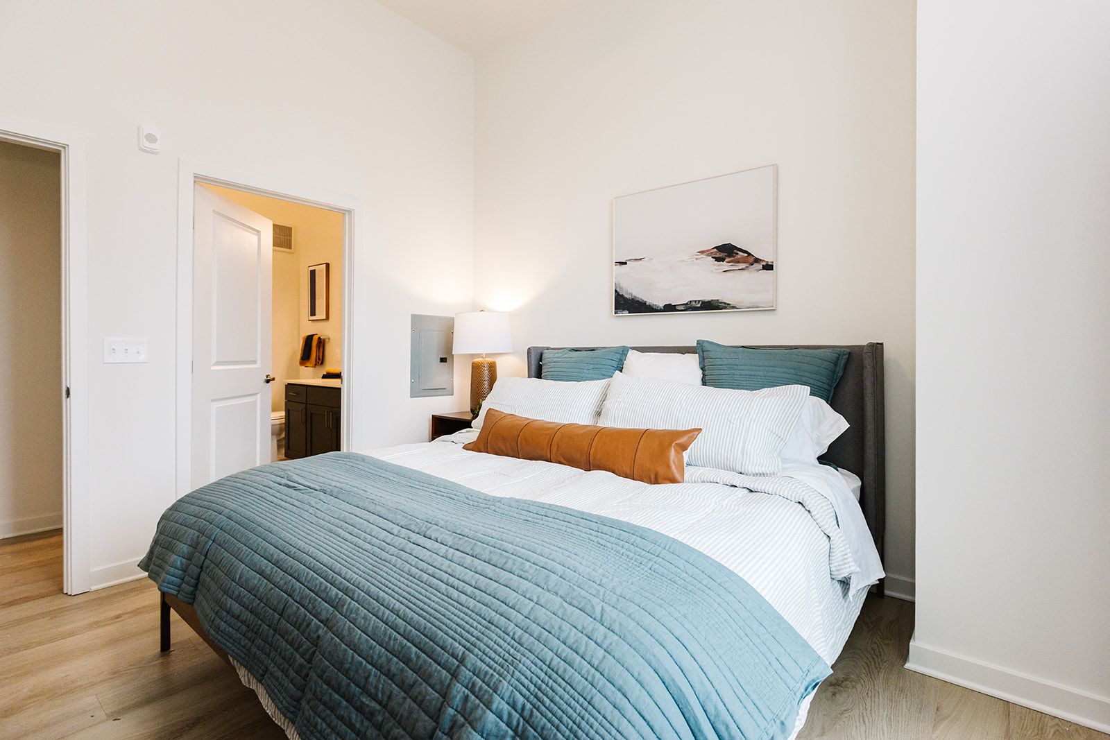Bedroom with modern furnishings at Opal Largo Station Apartments in Largo, MD.
