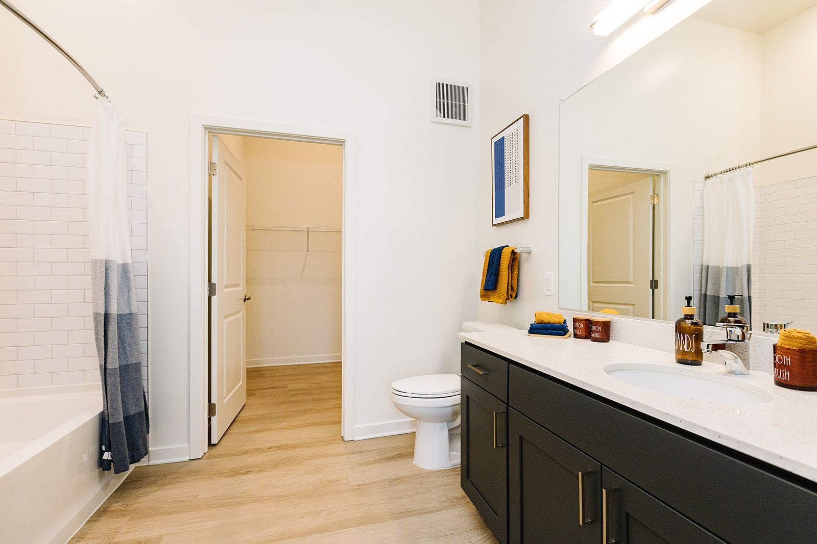 Spacious walk-in closet with built-in shelving at Opal Largo Station Apartments in Largo, MD.