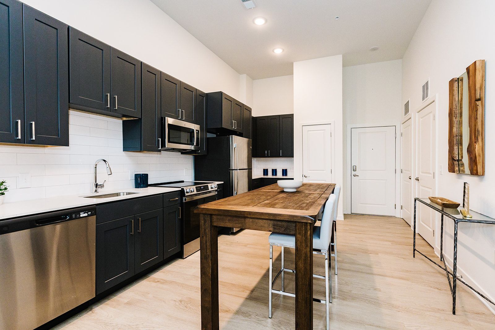 Modern kitchen with dark cabinets and stainless steel appliances at Opal Largo Station Apartments in Largo, MD.