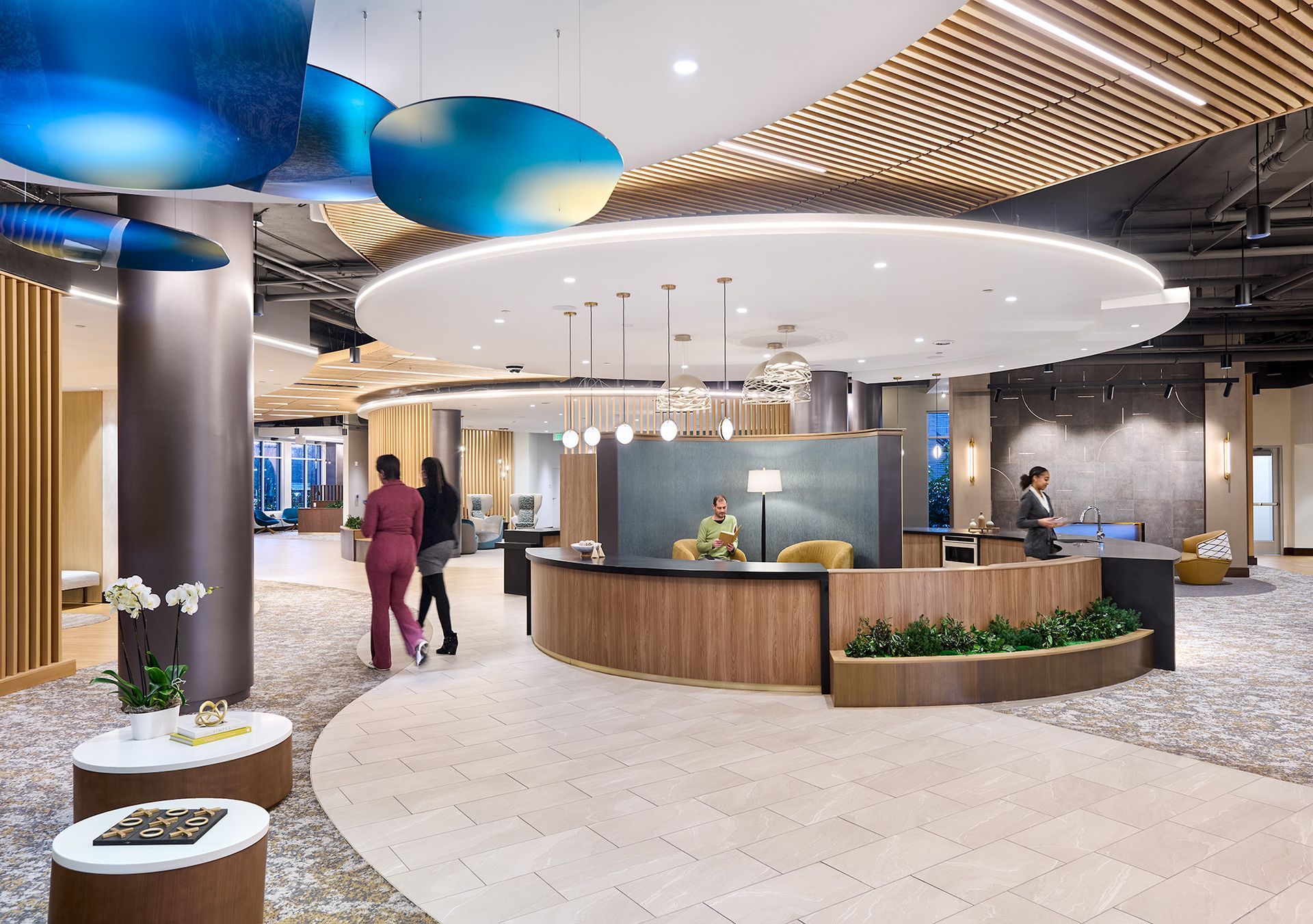 Modern reception area with curved desk and contemporary lighting at Opal Largo Station Apartments in Largo, MD.