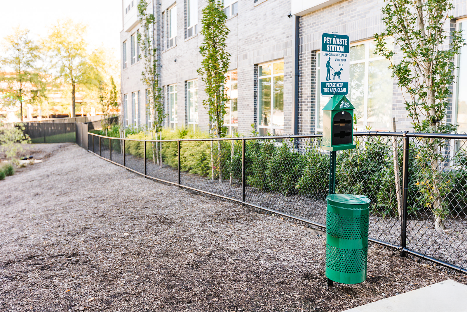 Fenced dog park with pet waste station at Opal Largo Station Apartments in Largo, MD.