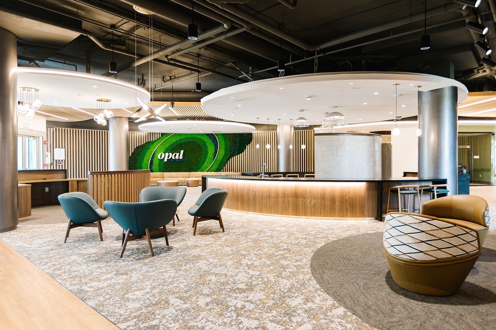 Modern resident lounge with seating and Opal feature wall at Opal Largo Station Apartments in Largo, MD.
