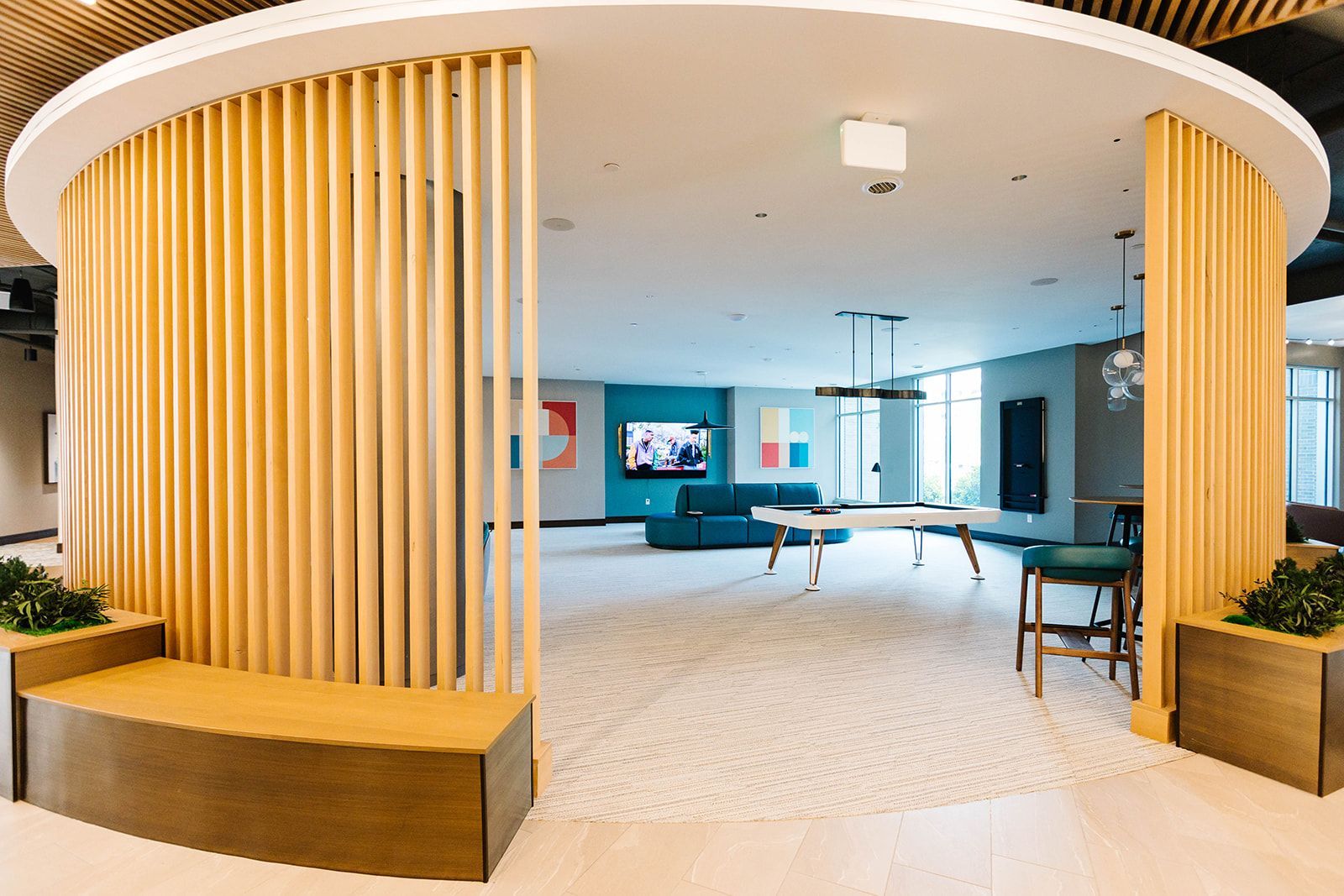 Modern resident lounge with wood accents and seating at Opal Largo Station Apartments in Largo, MD