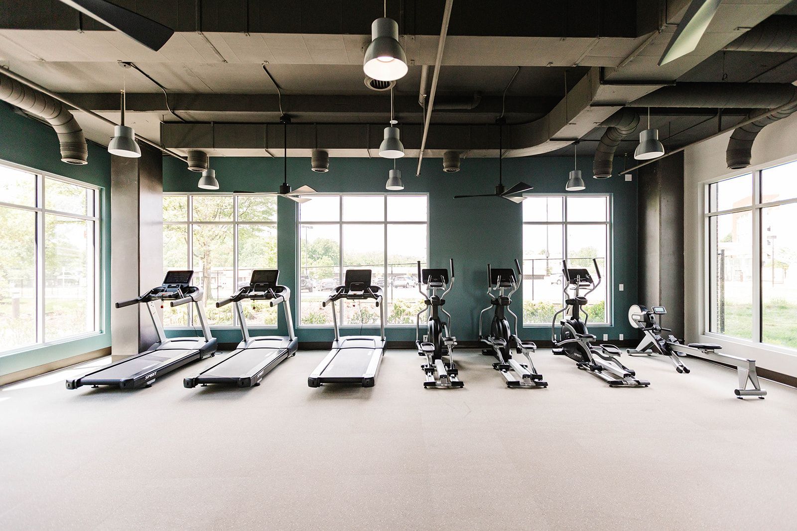 Fitness center with treadmills and cardio equipment at Opal Largo Station Apartments in Largo, MD.