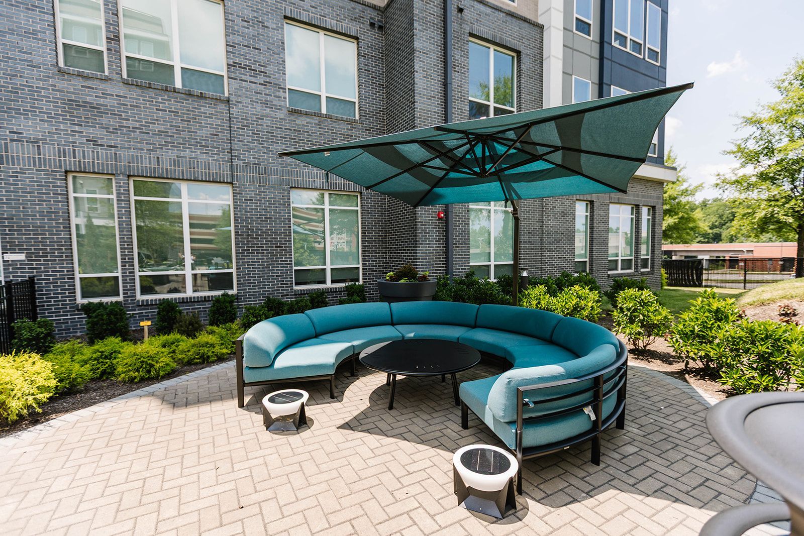 Outdoor courtyard with shaded lounge seating at Opal Largo Station Apartments in Largo, MD.