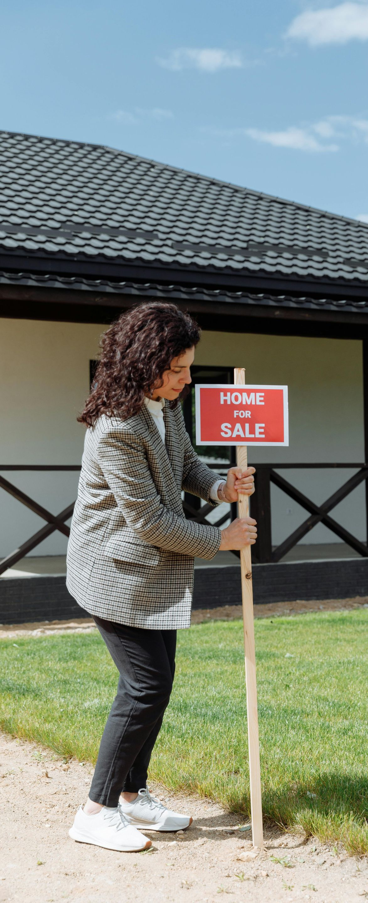 A person in a patterned blazer plants a