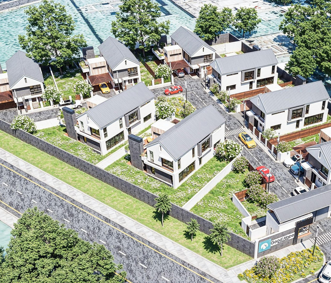 Aerial view of a modern residential cluster with white houses, gray roofs, and green lawns, accessed by a stone driveway.