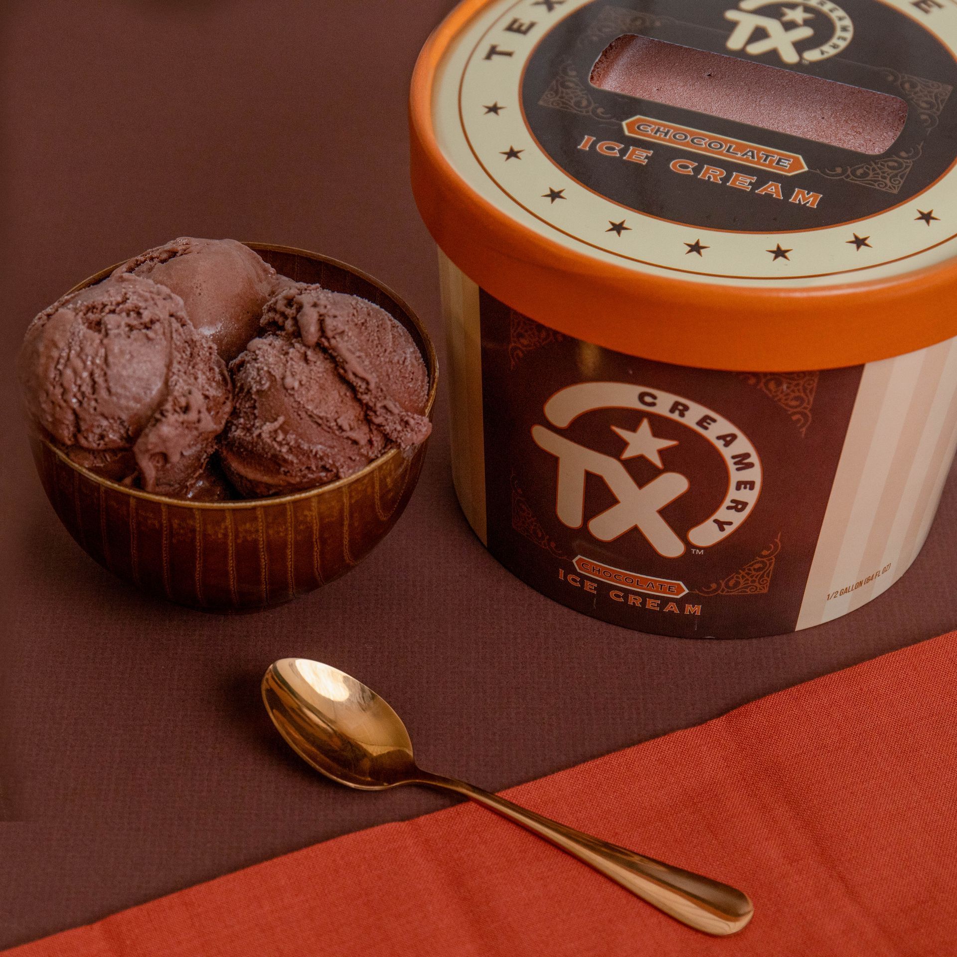 bowl of chocolate ice cream with half gallon of TX Creamery chocolate ice cream