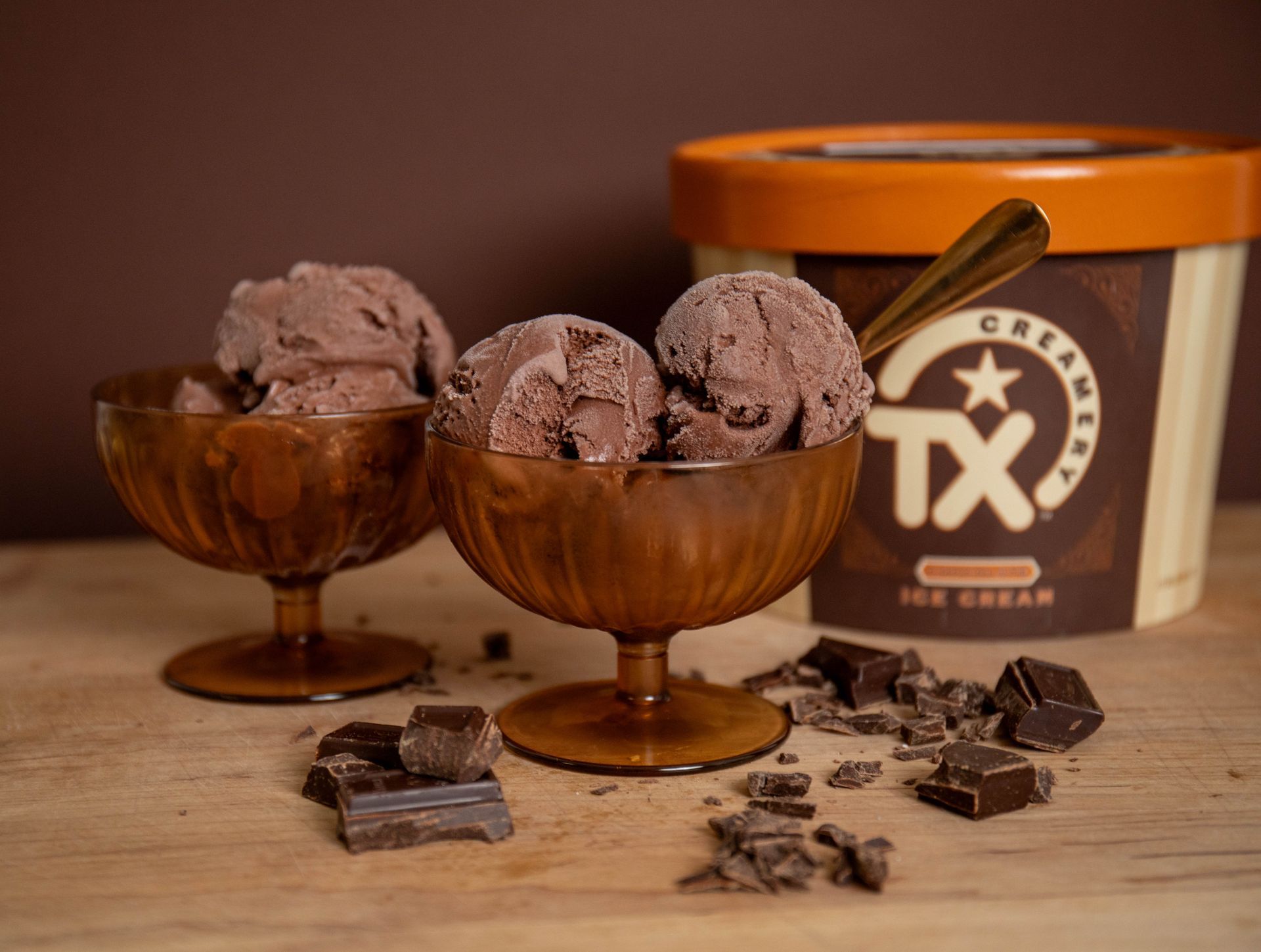 two bowls of chocolate ice cream with TX Creamery half gallon in the background