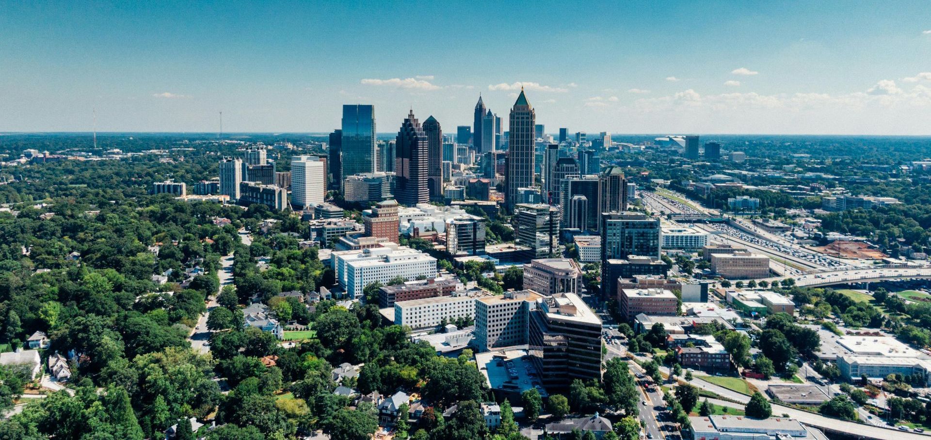 An aerial view of a city with lots of buildings and trees