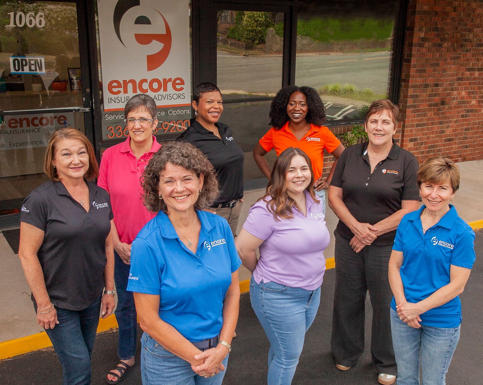 A group of business people are posing for a picture together